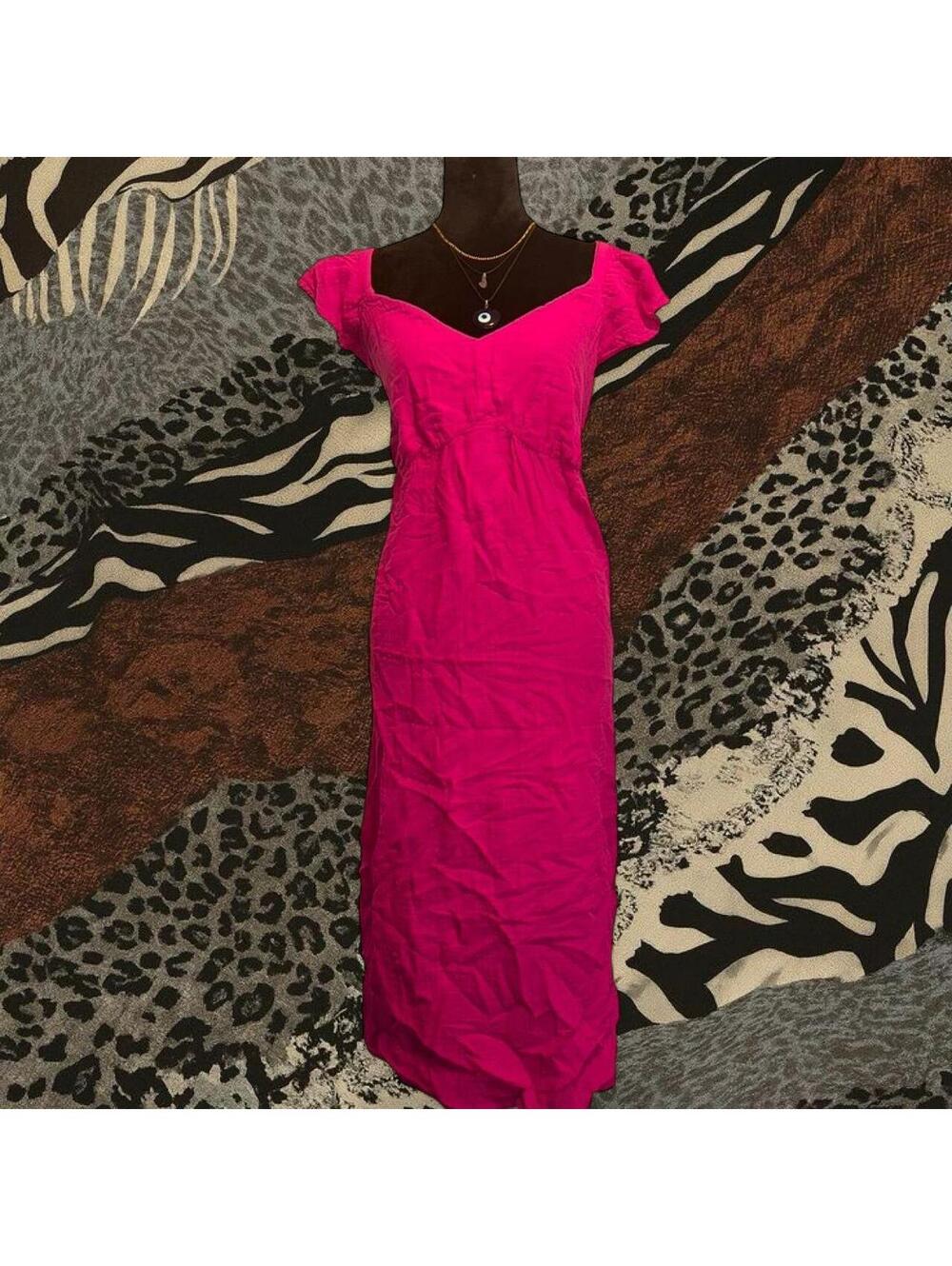 Pink maxi dress with ruched detailing and button closure.